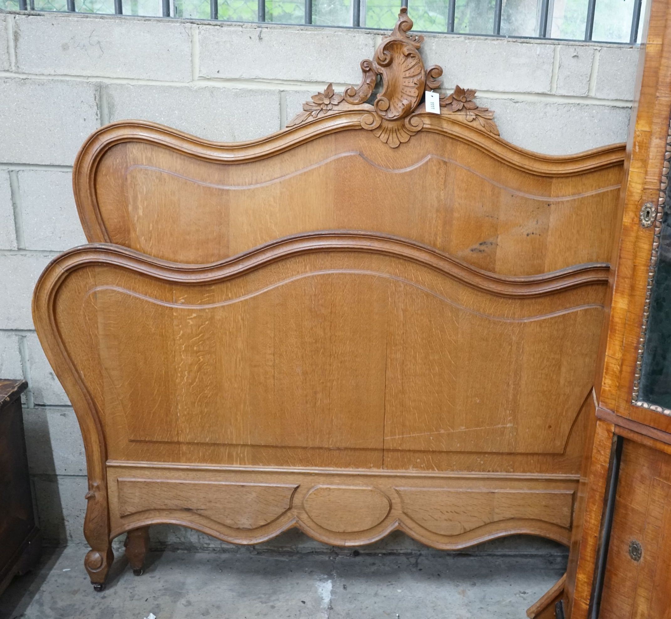 An early 20th century French carved oak double bedframe, width 136cm, headboard height 160cm